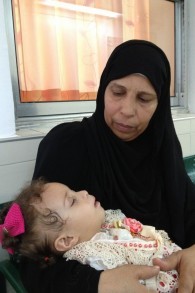 هنية شاعر مع الطفلة هلا بعد الفحص 12 اغسطس 2014 (بعدسة الحانان ميلر / طاقم تايمز أوف اسرائيل)