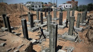 Palestinian workers rebuilding a house as reconstruction begins in the Shejaiya neighborhood of Gaza City, July 23, 2015. AP/Khalil Hamra