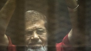 ارشيف - الرئيس المصري المخلوع محمد مرسي داخل قفص خلال محاكمته في القاهرة، 7 مايو 2016 (AFP PHOTO/KHALED DESOUKI)