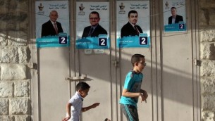 اطفال يلعبون امام ملصقات انتخابية في مدينة نابلس، 10 مايو 2017 (AFP/Jaafar Ashtiyeh)