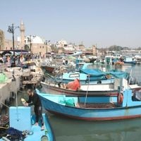 ACRE HARBOR, ISRAEL. Photographer Edgar Asher comments: The old harbour at Acre is a busy fishing port and a popular tourist attraction. The fishing boats and their reflections are picturesque and the eye is drawn to two fisherman in the foreground.