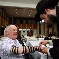 Jewish Care Disability Services. Rosh Hashanah service and kiddush at Malvern Chabad. David Fajgenbaum laying tephillin. Photo: Peter Haskin