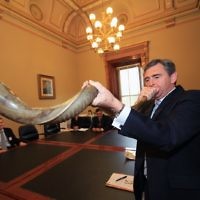 Rabbinical Council of Victoria meeting with former Victorian Premier John Brumby at Parliament House.  Brumby blowing the shofar in the Legislitive Council chanbers. Photo: Peter Haskin