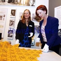 26-7-12. Australian Prime Minister Julia Gillard tours the Jewish Holocaust Museum and Research Centre with Head Curator Jane Josem.  Looking at a roll of fabric with the "Jude" star printed on it. Photo: Peter Haskin