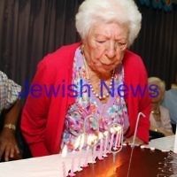 10-2-12. 100 year old Genia Simon blowing out tthe candles on her birthday cake with the help of her son, Charles Simon. Photo: Peter Haskin 10-2-12. 100 year old Genia Simon blowing out tthe candles on her birthday cake with the help of her son, Charles Simon. Photo: Peter Haskin