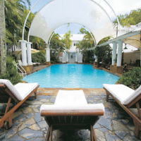 Relax by the pool at The Reef House in Palm Cove, Queensland.