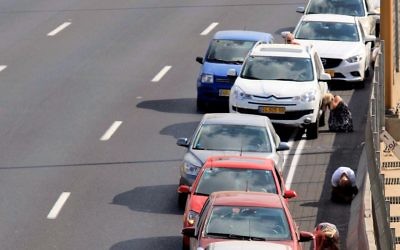 Tel Aviv drivers take cover as a siren sounds