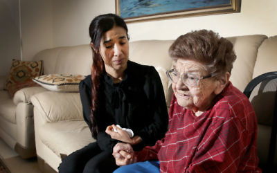 The moment when young Yazidi woman Nadia Murad met Holocaust survivor Luba Marczak in her Sydney apartment on August 22. Photo: Noel Kessel.