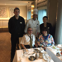 Rabbi Chaim Ingram and his wife Judith with chefs and waiters on the Ovation of the Seas.