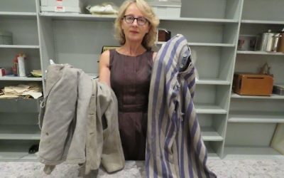 SJM head curator Roslyn Sugarman with the pair of Auschwitz prisoner’s pants and jacket donated by the Klunicki family last week. Photo: SJM