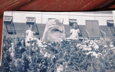 Local girls posing with the original memorial sculpture at Tatura.