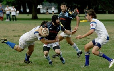 Maccabi first grader Daniel Munitz attempts to fend off the Lane Cove defence in his team’s 48-0 win at Lyne Park on April 22.
Photo: Shane Desiatnik