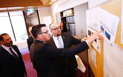 From left: Philip Dalidakis, Premier Daniel Andrews and Rabbi Gersh Lazarow study plans for the TBI upgrade during the Premier’s tour of the synagogue. Photo: Peter Haskin From left: Philip Dalidakis, Premier Daniel Andrews and Rabbi Gersh Lazarow study plans for the TBI upgrade during the Premier’s tour of the synagogue. Photo: Peter Haskin