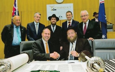 Jewish members of Parliament witness the completion of the Torah with Rabbi Shmueli Feldman and Rabbi Eli Gutnick. Photo: Andrew Taylor Jewish members of Parliament witness the completion of the Torah with Rabbi Shmueli Feldman and Rabbi Eli Gutnick. Photo: Andrew Taylor