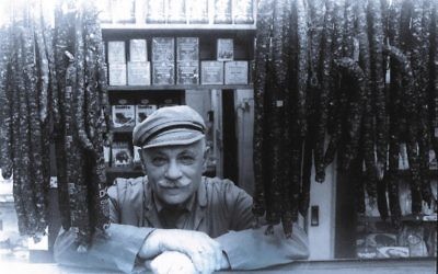 Mr Benedykt behind the counter in Benedykt Delicatessen in Acland Street in the 1970s.
