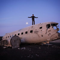Dovi Broner is pictured on the wreckage of a US Navy plane in Iceland. Dovi Broner is pictured on the wreckage of a US Navy plane in Iceland.