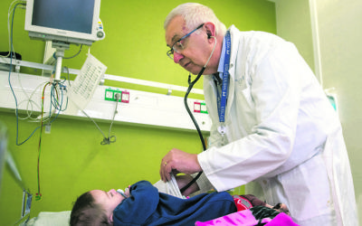 Professor Anthony Luder examines an infant at Ziv Hospital in Israel. Professor Anthony Luder examines an infant at Ziv Hospital in Israel.