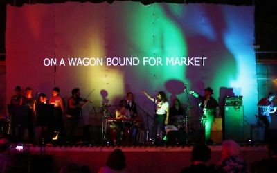 YID! performs Dona Dona in Yiddish at In One Night concert, with the English translation of the lyrics projected above the stage.	Photo: Peter Haskin