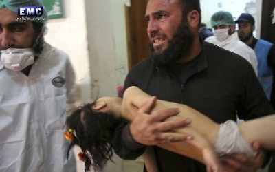 Following the suspected chemical attack, a man carries a child into a makeshift hospital in the town of Khan Sheikhoun. Photo: Edlib Media Center, via AP Following the suspected chemical attack, a man carries a child into a makeshift hospital in the town of Khan Sheikhoun. Photo: Edlib Media Center, via AP