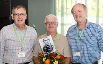 From left: Sydney brothers Geoff Solomon, Adrian Paul and John Shrimski and a photograph of their ancestor Mordecai Solomon.