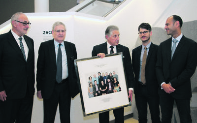 From left: Gus Lehrer, Norman Selingman and Robert Schneider from the SJM presenting a framed photograph to relatives of Isaac and Susan Wakil, Adam Lippmann and David Khedoori. Photo: Shane Desiatnik