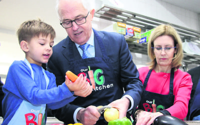 Look, this is how you do it! Jack at Our Big Kitchen with his grandfather, Prime Minister Malcolm Turnbull, and Vaucluse MP Gabrielle Upton.
Photo: Shane Desiatnik