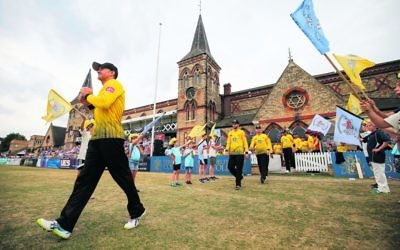 Michael Klinger leads Gloucestershire onto the College Ground at the Cheltenham Cricket Festival in England. A frosted glass window featuring a Magen David can be seen in the background. Photo: Gloucestershire Cricket