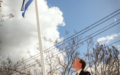 Dvir Abramovich raises Israel's flag at St Kilda Town Hall. Photo: Sav Schulman