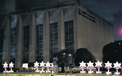 Stars of David with the names of those killed stand in front of the Tree of Life Synagogue. Photo: AP Photo/Matt Rourke