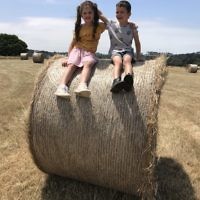Yael Rothschild entered this photo of Jacob and Laila Richardson sitting on a bail of hay at at Point Leo, Victoria.