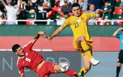 Tom Rogic (right) of Australia in action against Tamer Seyam (left) of Palestine during last Friday's match. Photo: EPA/Mahmoud Khaled