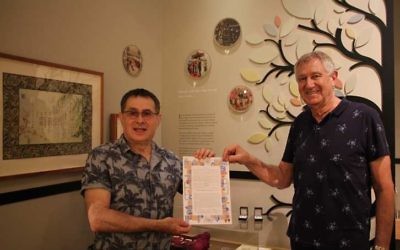Ilan Buchman and Oscar Shub hold their ketubah in front of the Sydney Jewish Museum's marriage display. Photos: Sophie Deutsch