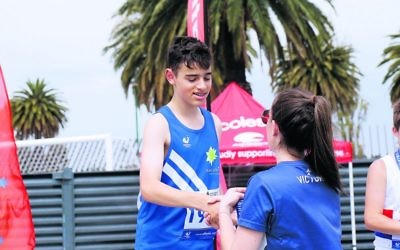Ori Drabkin collecting one of his three gold medals at the Victorian T&F Championships. Photo: Peter Haskin