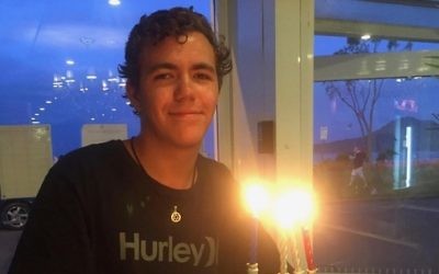 Kurt Brown lighting a menorah.