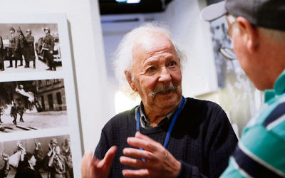 Henri Korn, Holocaust survivor and guide at the Jewish Holocaust Centre, speaks with visitors. Photo: Peter Haskin