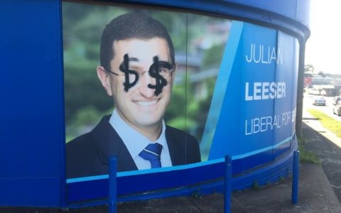 The poster for Berowra MP Julian
Leeser defaced with dollar signs
over his eyes.