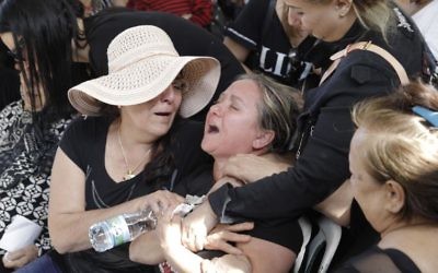 The family of Moshe Agadi at his funeral in Ashkelon last Sunday. Photo: AP Photo/Sebastian Scheiner
