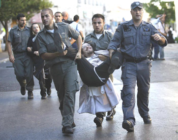   Police arrest an ultra-Orthodox demonstrator in Jerusalem on June 27.