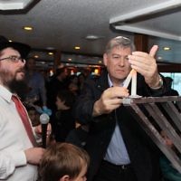 Rabbi Motti Feldman and Dr Andi Garfagnini lighting a Menorah during Dover Heights Shul Chanukah celebrations on Sydney Harbour. Rabbi Motti Feldman and Dr Andi Garfagnini lighting a Menorah during Dover Heights Shul Chanukah celebrations on Sydney Harbour.