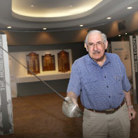 Graham de Vahl Davis with his father’s sword, which he used while serving Australia and which is now exhibited at the Sydney Jewish Museum. Photo: Ingrid Shakenovsky