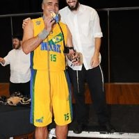 206 centimetre Brazilian basketballer Israel Andrade takes time out to lay tefillin after winning gold. Photo: Henry Benjamin.
