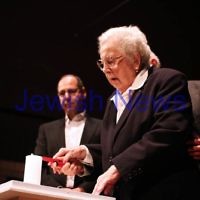 Yom Hashoah 2012. Robert Blackwood Hall, Monash University. Regina Kamieniecki lighting a memorial candle. Photo: Peter Haskin