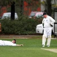 10-11-13. Cricket. AJAX first XI v Monash at Monash University. David Fayman stretching at first slip with keeper Leon jacobs looking on. Photo: Peter Haskin