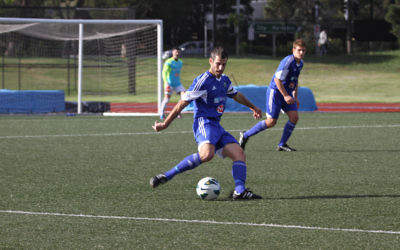 Club president and player, Michael Katz, clears the ball from defence