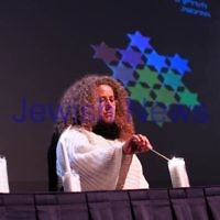 4-5-14. Yom Ha Zikaron 2014. Robert Blackwood Hall, Monash University. Ofrit Maoz lights a candle for the fallen from the Arava. . Photo: Peter Haskin