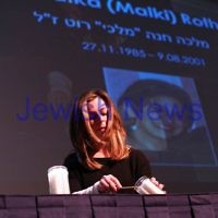 4-5-14. Yom Ha Zikaron 2014. Robert Blackwood Hall, Monash University. Romy Lipson lights a candle for her cousin Malka "Malki" Roth. Photo: Peter Haskin