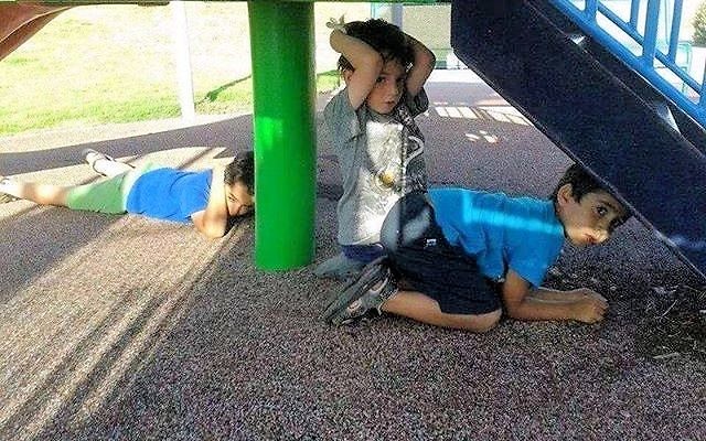 Israeli children take cover during a rocket attack.
Ashernet