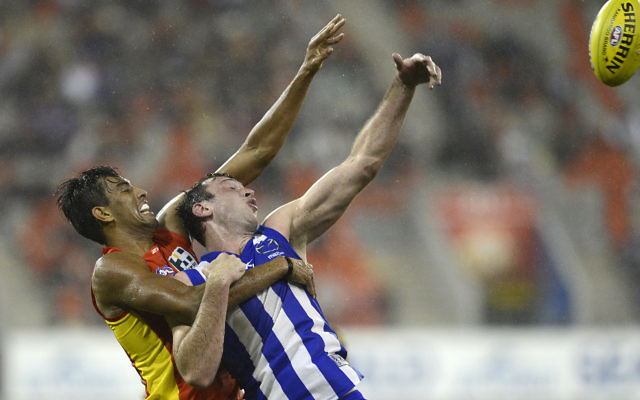 Todd Goldstein (right) holds off Gold Coast Suns Tom Nicholls at Metricon Stadium earlier this year. Photo: AAP Image/Dan Peled