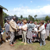 Linda Reitzin and her friend Chris present gifts of soccer balls to teachers and World Vision sponsored children at a Kenyan school in June 2014. 
