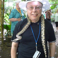 Rabbi Chaim Ingram of Sydney with a snake in the Secret Garden in Port Vila, Vanuatu